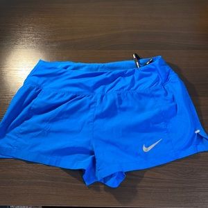Women’s small blue Nike running shorts.